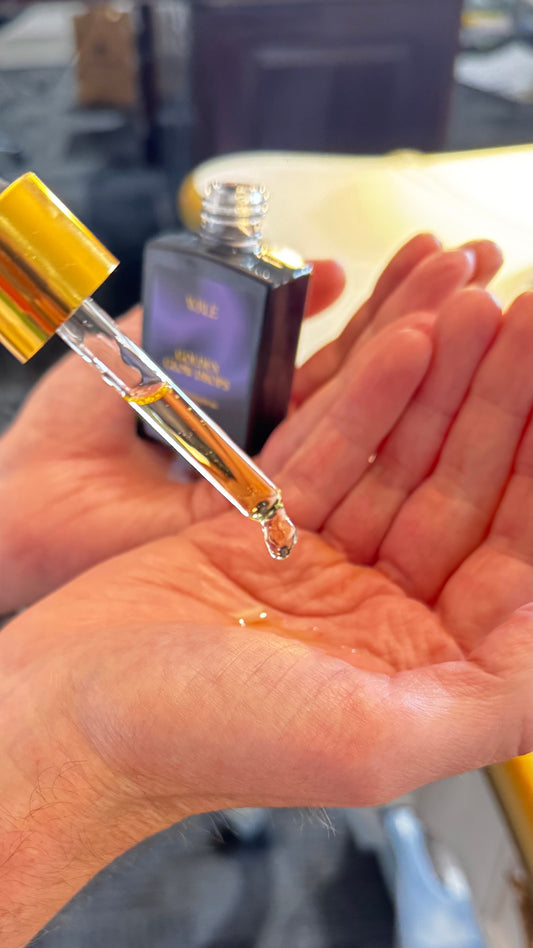pouring WRLE's face oil into the palms to warm up.