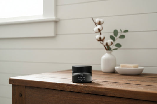 Black jar labeled 'WLRE Calming' on a wooden surface with a blurred background