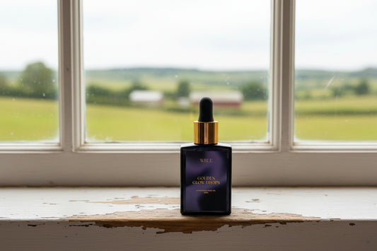 Black bottle with gold cap labeled Golden Glow Drops' on a white background