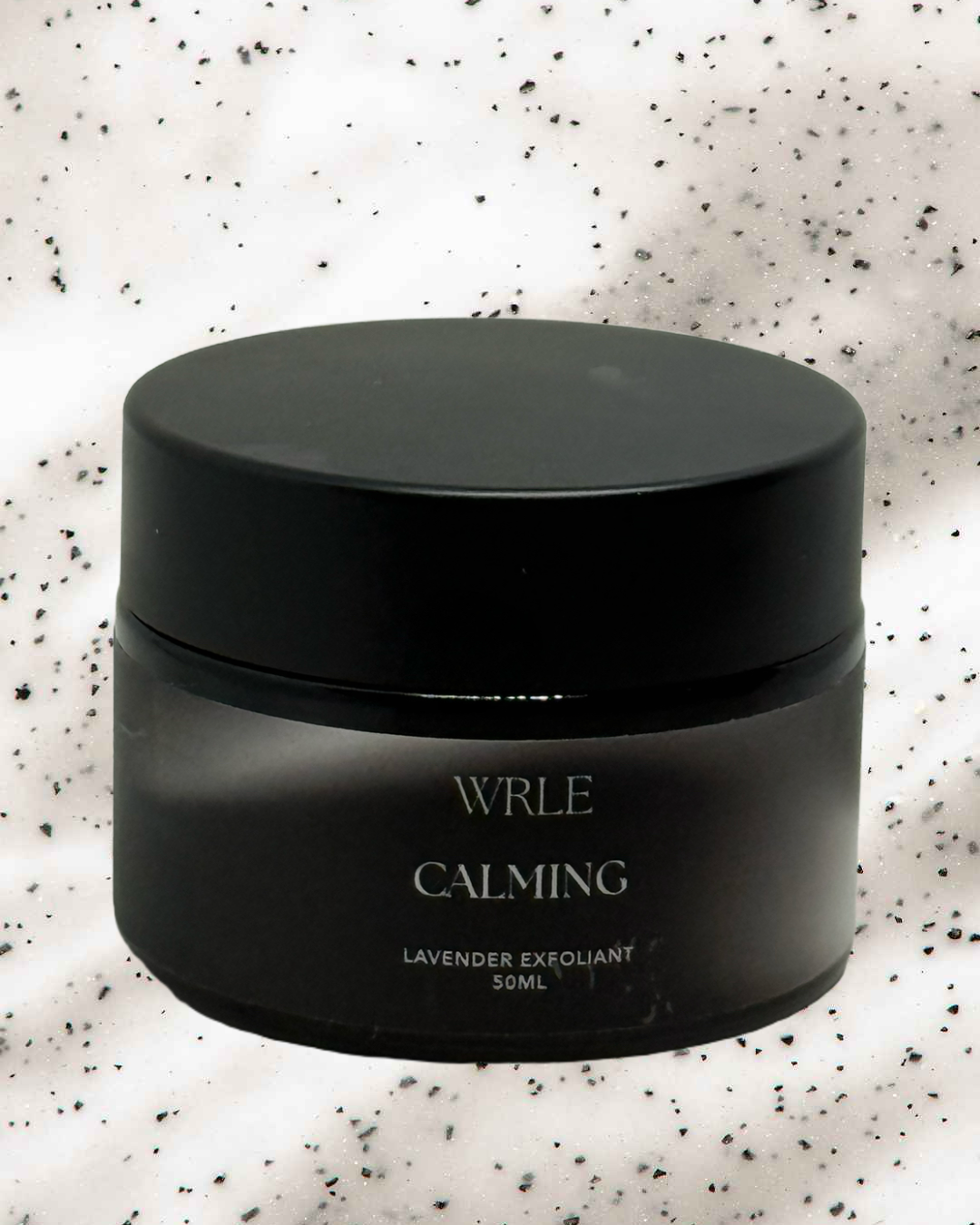Black jar labeled 'WRLE Calming' on a textured white background