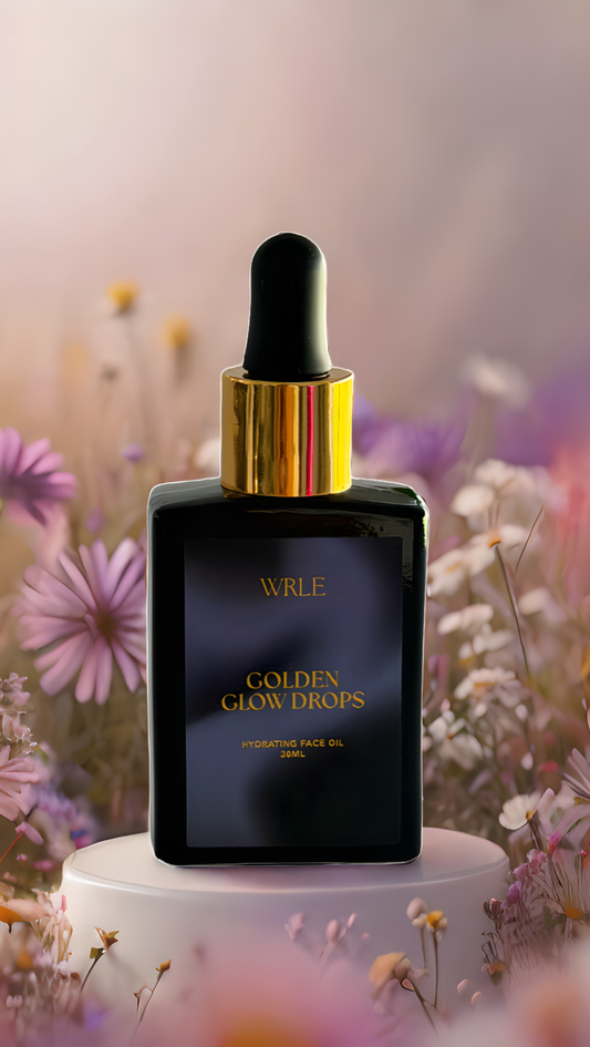 WRLF Golden Glow Drops face oil bottle with dropper against a floral background